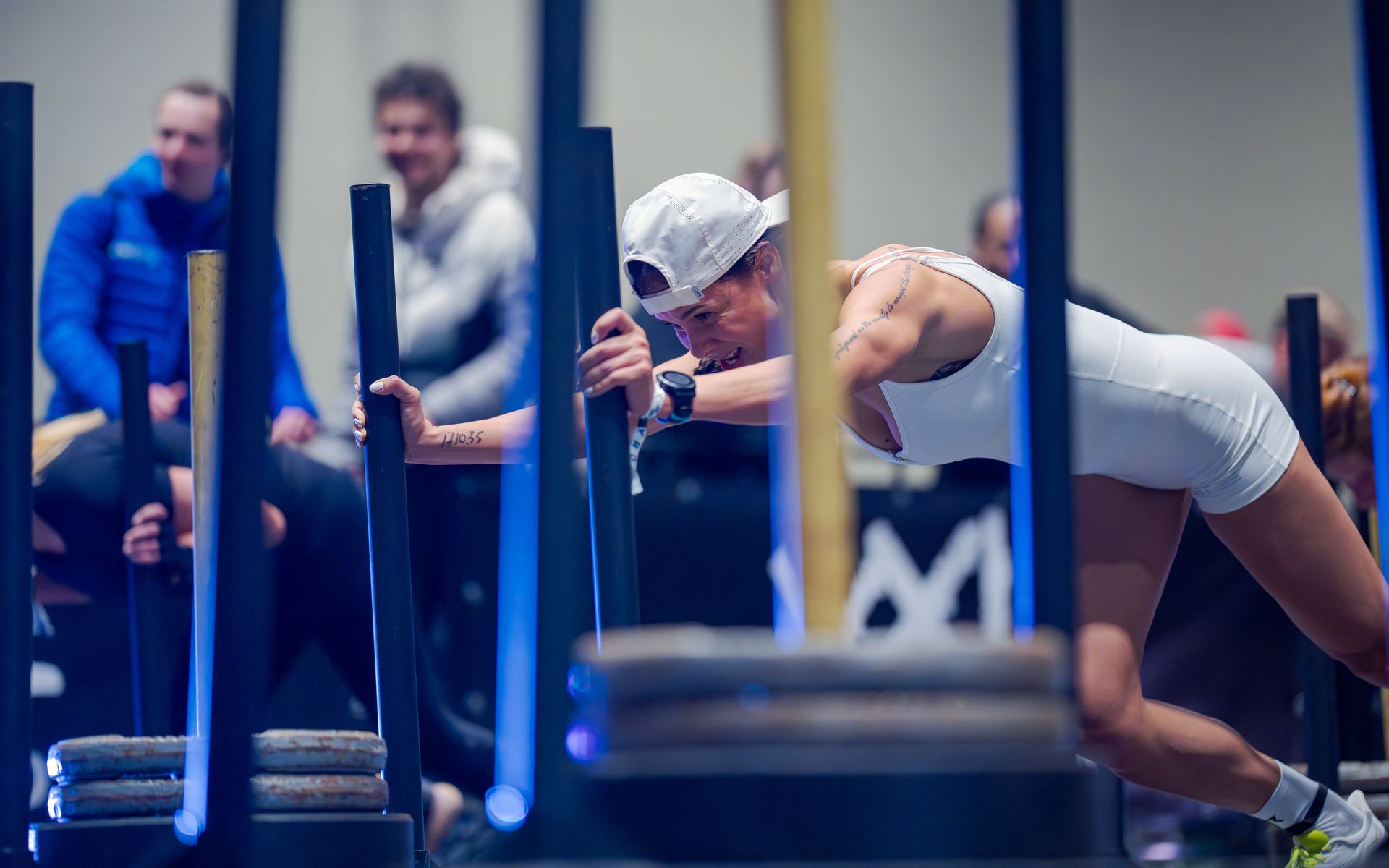 Athlete pushing a sled at a HYROX race