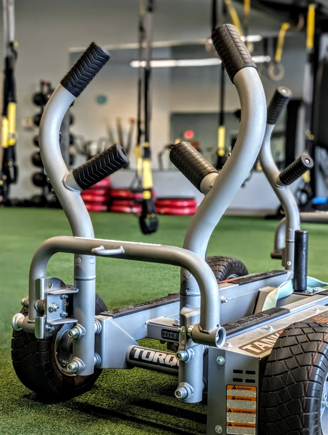 Training turf with sled and TRX rig at VIVE Health & Fitness