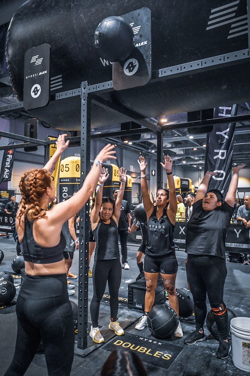 Athletes throwing wall balls
